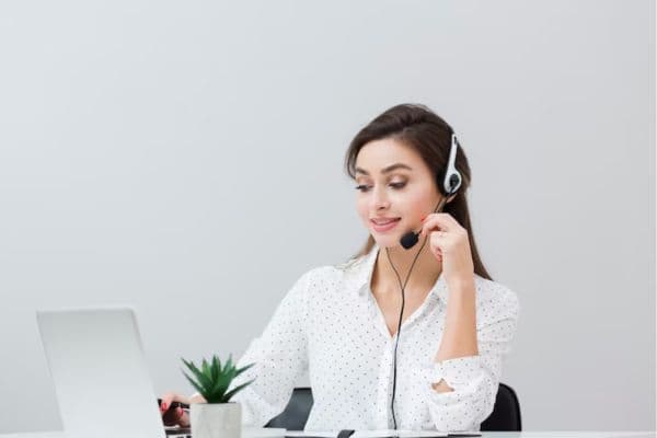 A beautiful girl sitting on desk wearing headphone